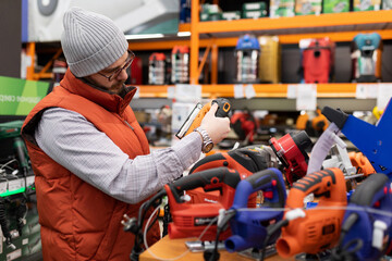 a customer in a non-power tool store chooses a new electric jigsaw for himself, the concept of a...