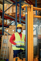 Worker in uniform working on warehouse