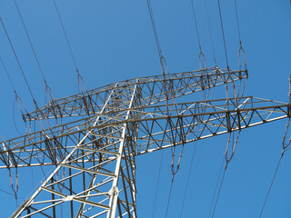 High voltage wires. Energy supply. Metal poles of electrical wires.