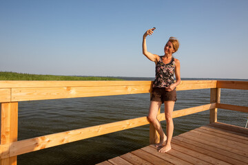 View of a relaxing mature woman standing on a pier