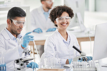 smiling female scientist at the workplace in the laboratory.