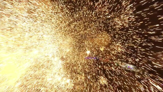 FPV drone flies through exploding fireworks; celebrations at night