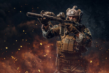 Combative soldier aiming rifle against dark background with explosion