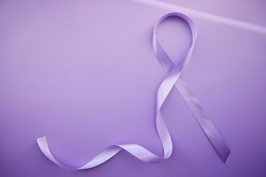 Purple ribbon for Purple Day - World Epilepsy Day, March of 26. Symbol of Epilepsy Day on purple background with shadows