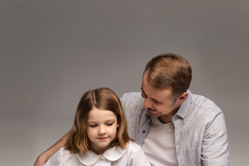 portrait of happy father and cheerful son, cute boy playing with dad in the house, child hugging father, dad playing with children, dad hugs daughter