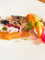 close up contemporary recipe of sea bass lemon chutney with potato and caramelized red onions...