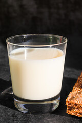 Glass of milk against dark background