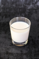 Glass of milk against dark background