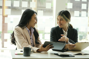 Meeting young asian women and discussing in the room, face to face looking and smile.