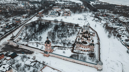 The ancient monastery behind the fortress wall. Beautiful churches with domes. Old Russian architecture. Winter day.