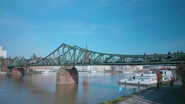 Eiserner Steg of Frankfurt am Main Bridge over the river Main with people on a sunny day
