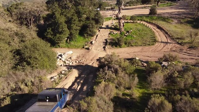 Off roader pick up truck driving on extreme course, aerial following view