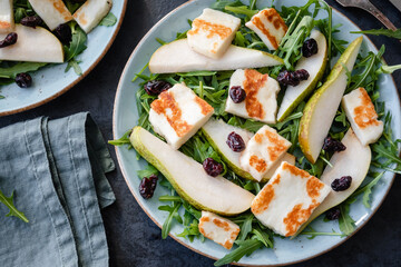 Salad with Halloumi cheese, pear, arugula, and cranberry