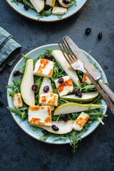 Salad with Halloumi cheese, pear, arugula, and cranberry