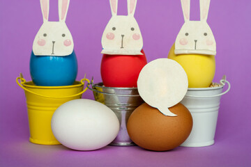 Easter eggs with Rabbit ears in colored buckets, selective focus image, Card Happy Easter	
