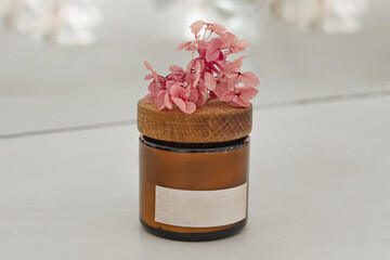 One dark amber glass cosmetic bottle with a white label on the table. Close up, copy space. Beauty blog, salon treatment concept, minimalist brand packaging mockup