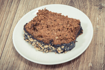 Homemade pastry made of zucchini with nuts and raisin. Wooden background