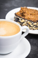 Zucchini dough on plate and cup of white coffee. Delicious dessert
