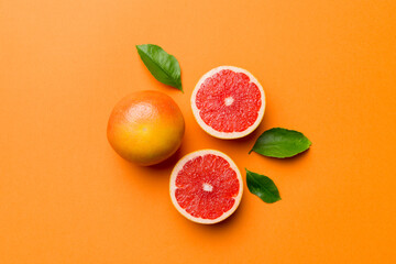 fresh Fruit grapefruit with Juicy grapefruit slices on colored background. Top view. Copy Space. creative summer concept. Half of citrus in minimal flat lay with copy space