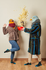 Couple dressed as birds have a surprise for popcorn in the air