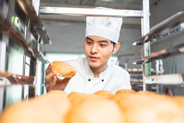Smiling  asian young man bakers looking at camera..Chefs  baker in a chef dress and hat, cooking...