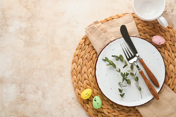 Easter table setting. Easter dinner with multicolored easter eggs. Elegance pastel and beige...