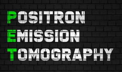 Fototapeta na wymiar Positron emission tomography (PET) concept,healthcare abbreviations on black wall