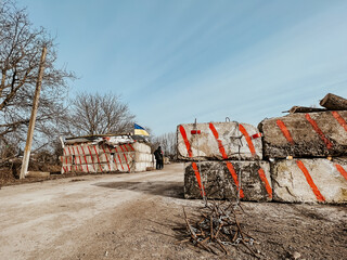 12.03.2022 Irpin, Ukraine: Homemade iron thorns to stop enemy cars, self-made checkpoint at the entrance to the village to check cars and detect saboteurs or stop enemy vehicles. - obrazy, fototapety, plakaty