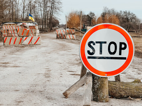 12.03.2022 Irpin, Ukraine: self-made checkpoint at the entrance to the village to check cars and detect saboteurs or stop enemy vehicles. The yellow and blue flag of Ukraine is hoisted over the post