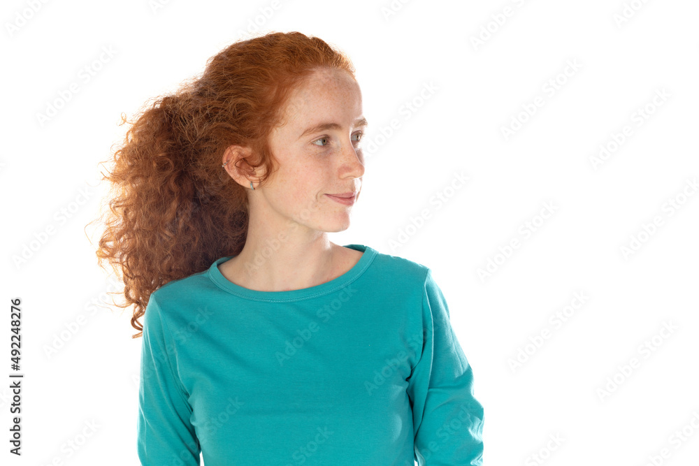 Wall mural Pretty redhead young woman with long wavy hair and freckles