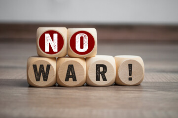 Cubes, dice or blocks with message say no to war on wooden background
