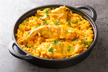 Fragrant rice with vegetables and rabbit meat close-up in a frying pan on the table. horizontal