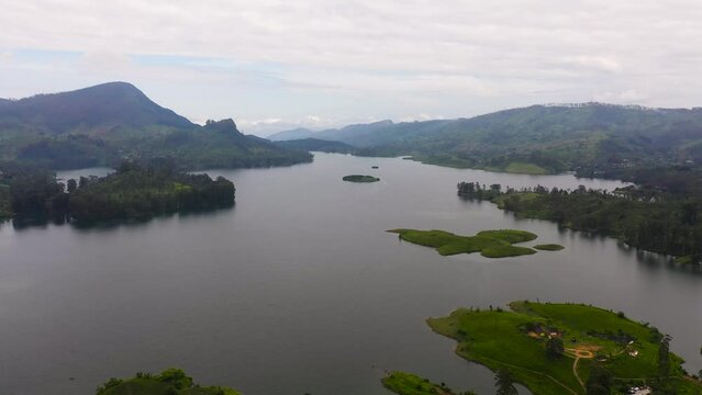 Aerial view of lake in the mountains among tea estates and plantations Maskeliya, Sri Lanka.