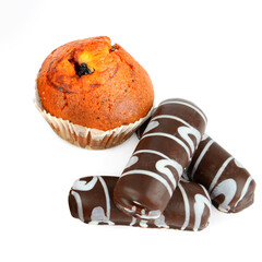 Cookies and muffins isolated on white .
