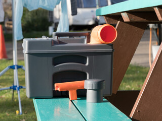 A motorhome recreational vehicle's cassette toilet sits on a bench drying and airing after being...