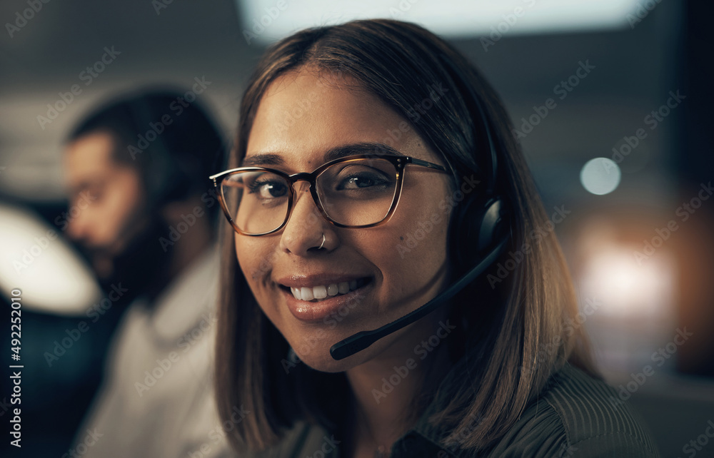 Poster She has the expertise to handle any call. Portrait of a call centre agent working in an office at night.