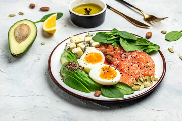 Ketogenic diet breakfast. salmon, avocado, cheese, egg, spinach and nuts. Healthy fats, clean...