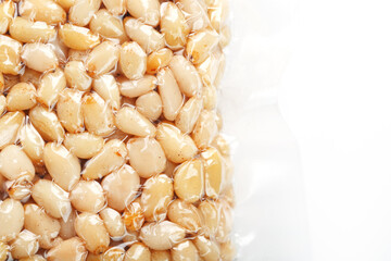Pine nuts in a transparent vacuum package over