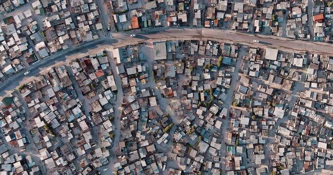 Poverty.Inequality.Straight down high aerial fly over view of the densely populated Khayelitsha township on the Cape Flats, Cape Town, South Africa
