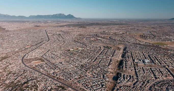 Poverty.Inequality.High aerial fly over view of the densely populated Khayelitsha township on the Cape Flats, Cape Town, South Africa