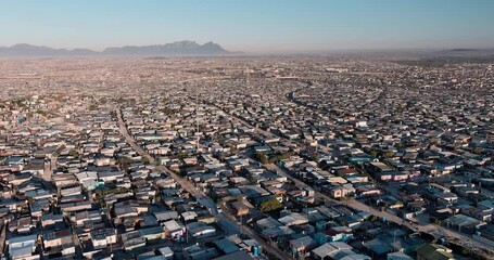Poverty.Inequality.Aerial fly over view of the densely populated Khayelitsha township on the Cape Flats, Cape Town, South Africa