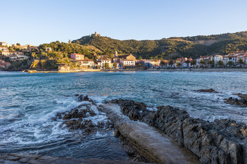 Fort Saint-Elme et Moulin de la Cortina au-dessus de la plage du Port d&rsquo;Avall &agrave; Collioure au coucher du soleil par un temps temp&eacute;tueux (Occitanie, France)