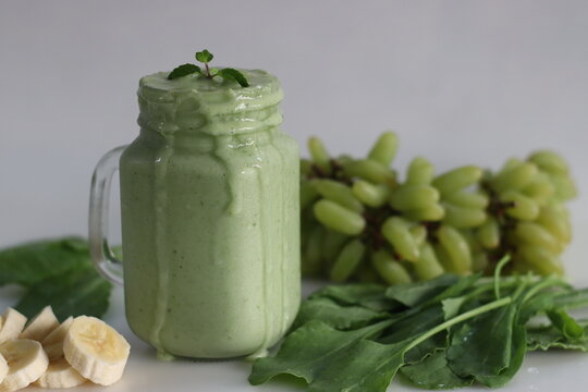 Green Smoothie Made Of Frozen Green Grapes, Fresh Baby Spinach, Bananas And Almond Milk. Served In Mason Jar