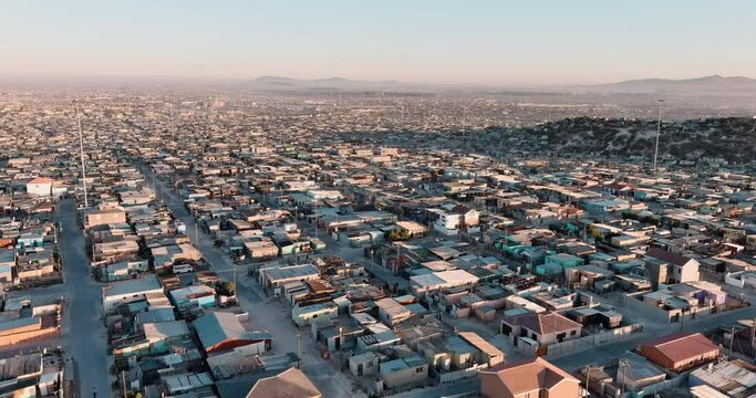 Poverty.Inequality.Aerial close-up fly over view of the densely populated Khayelitsha township on the Cape Flats, Cape Town, South Africa