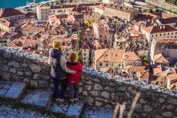 Mom and son travelers in Montenegro in Kotor Old Town Ladder of Kotor Fortress Hiking Trail. Aerial drone view