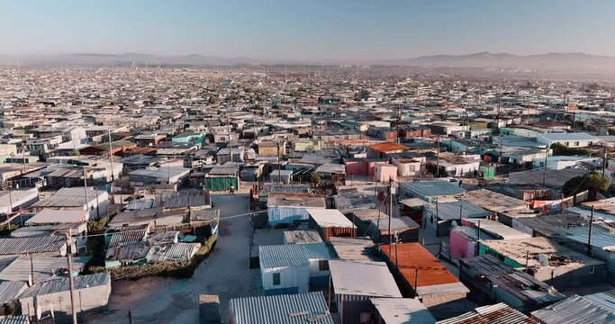 Poverty.Inequality.Aerial close-up fly over view of the densely populated Khayelitsha township on the Cape Flats, Cape Town, South Africa
