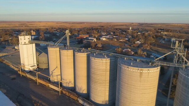Aerial of grain storage elevator facility in small town USA