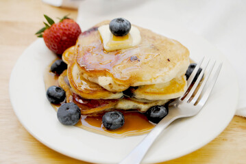 Healthy Strawberry and Blueberry Pancakes Served with Syrup	