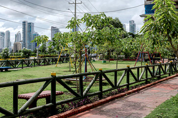 Fototapeta premium Beautiful park surrounded by large buildings in a residential area of the city.