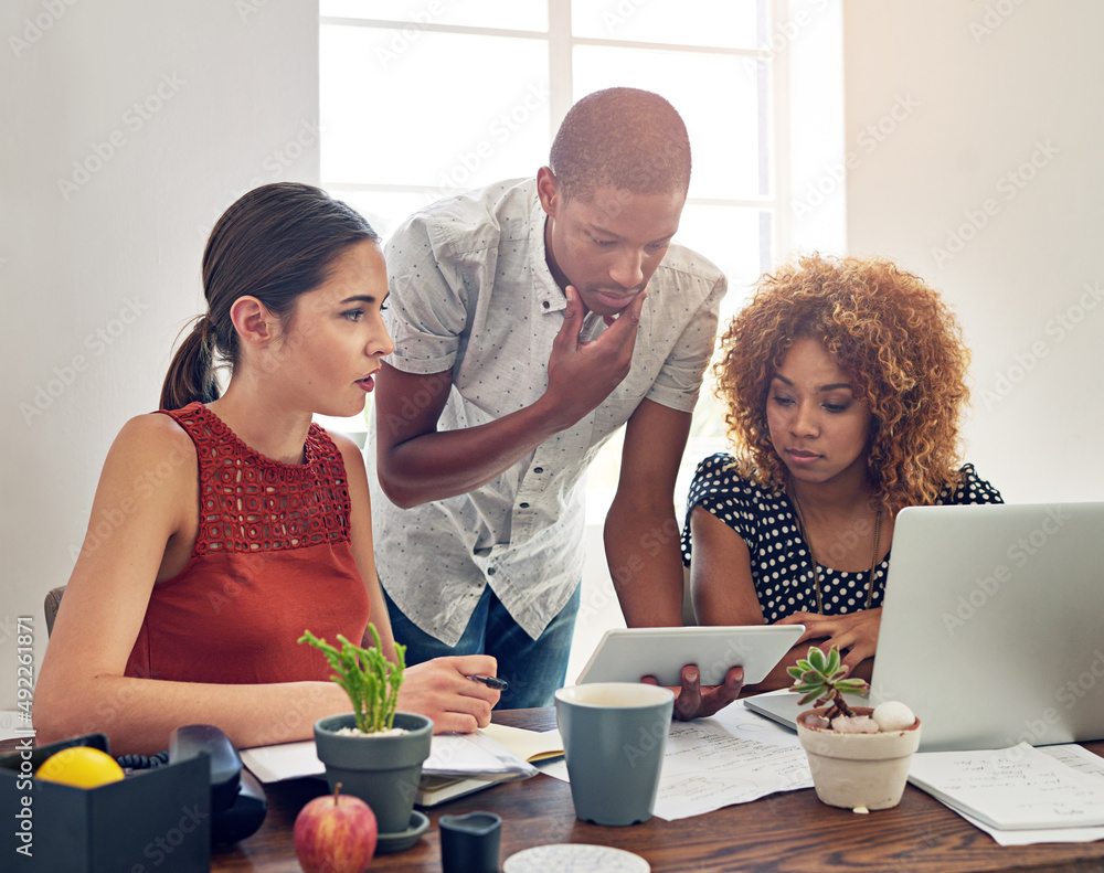 Aufkleber theyre problem solving specialists. shot of a group of colleagues working together at a desk in an o